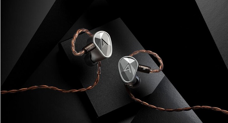 Clarus IEMs with cable attached on a grey background
