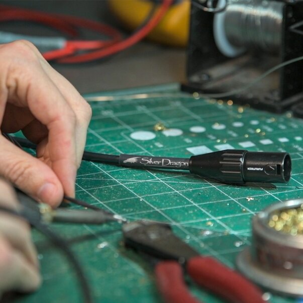 close up of a silver dragon audio cable in construction