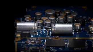 Dual large solid high polymer capacitors