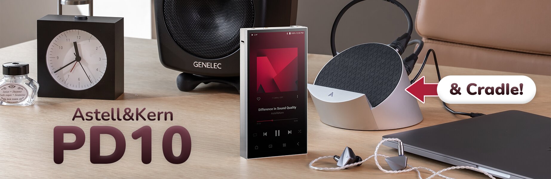 Astell&Kern PD10 & Cradle on table with alarm clock, IEMs, speaker, and laptop nearby