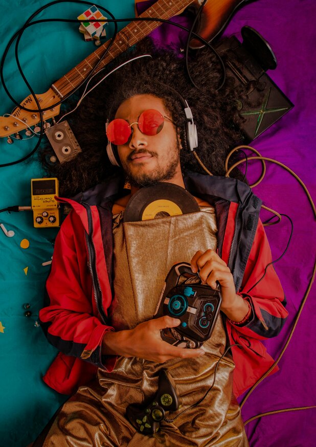 Man laying on ground surrounded by vintage audio gear