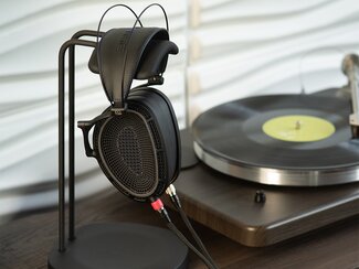Dan Clark Audio Expanse Headphones on a headphone stand next to a turntable