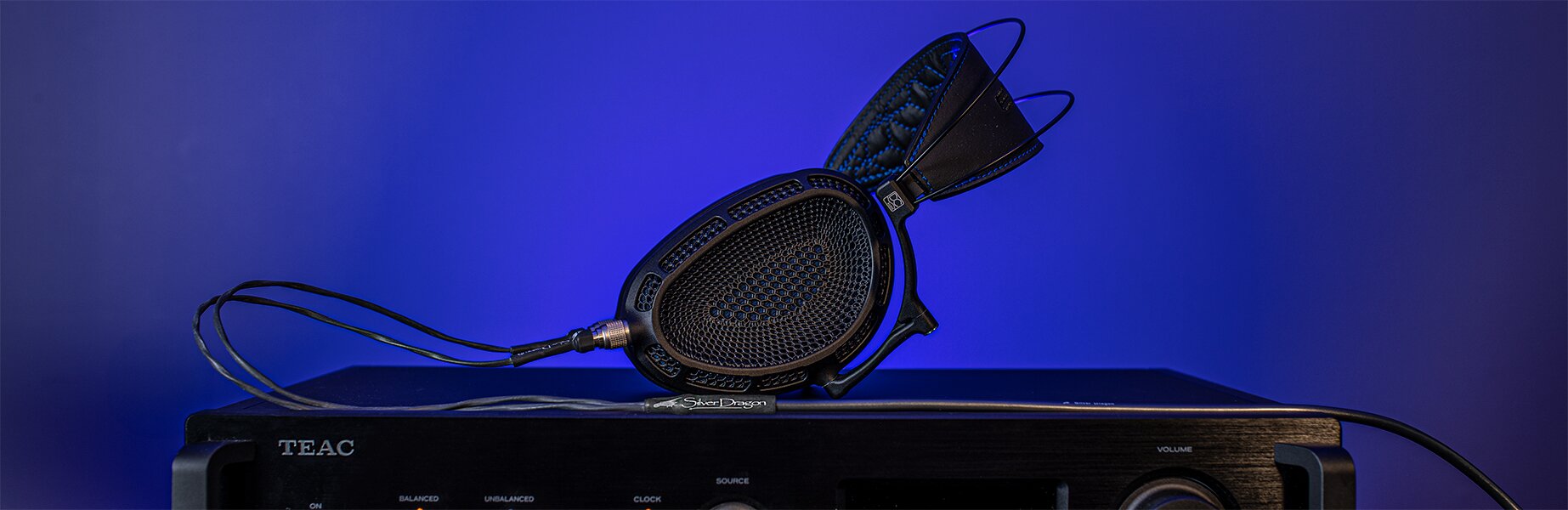 dan clark audio expanse headphones connected to a silver dragon headphone cable 
