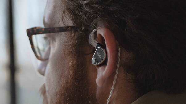 man wearing the 64 audio tia in-ear monitor in left ear