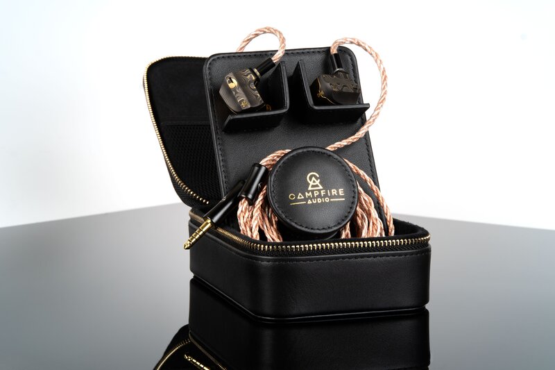 Campfire Audio Chimera IEMs connected to IEM cable and placed upright inside of hardshell carrying case