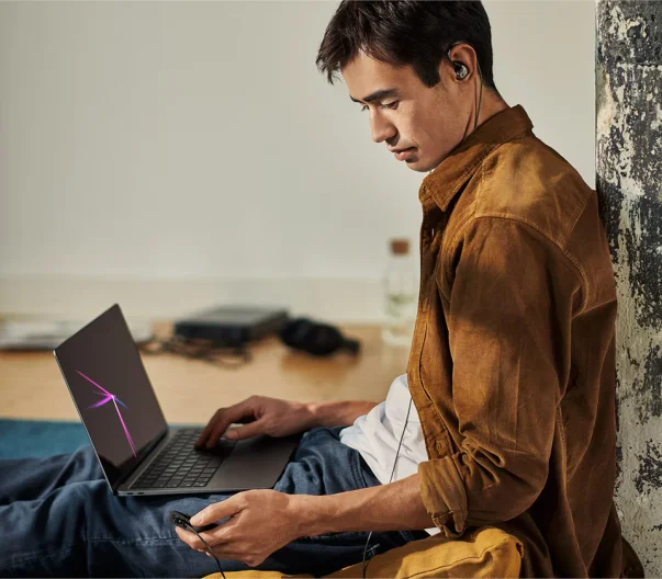 man wearing Sennheiser IE600 IEM sitting with laptop on his lap