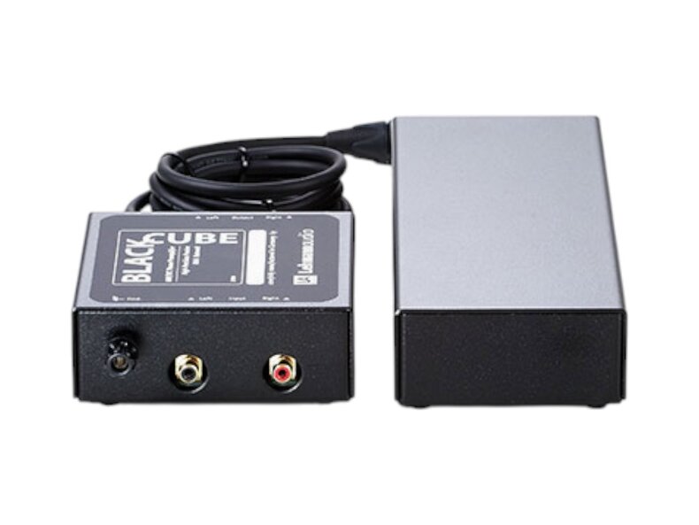 black cube, power, and cord facing us