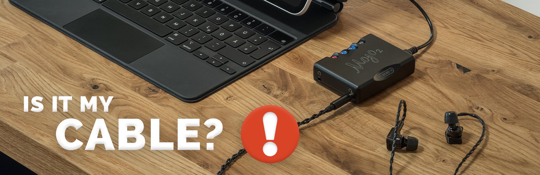 Laptop with Chord Mojo 2 next to it connected to a pair of IEMs