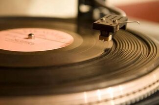 cartridge stylus and tonearm on a vinyl record