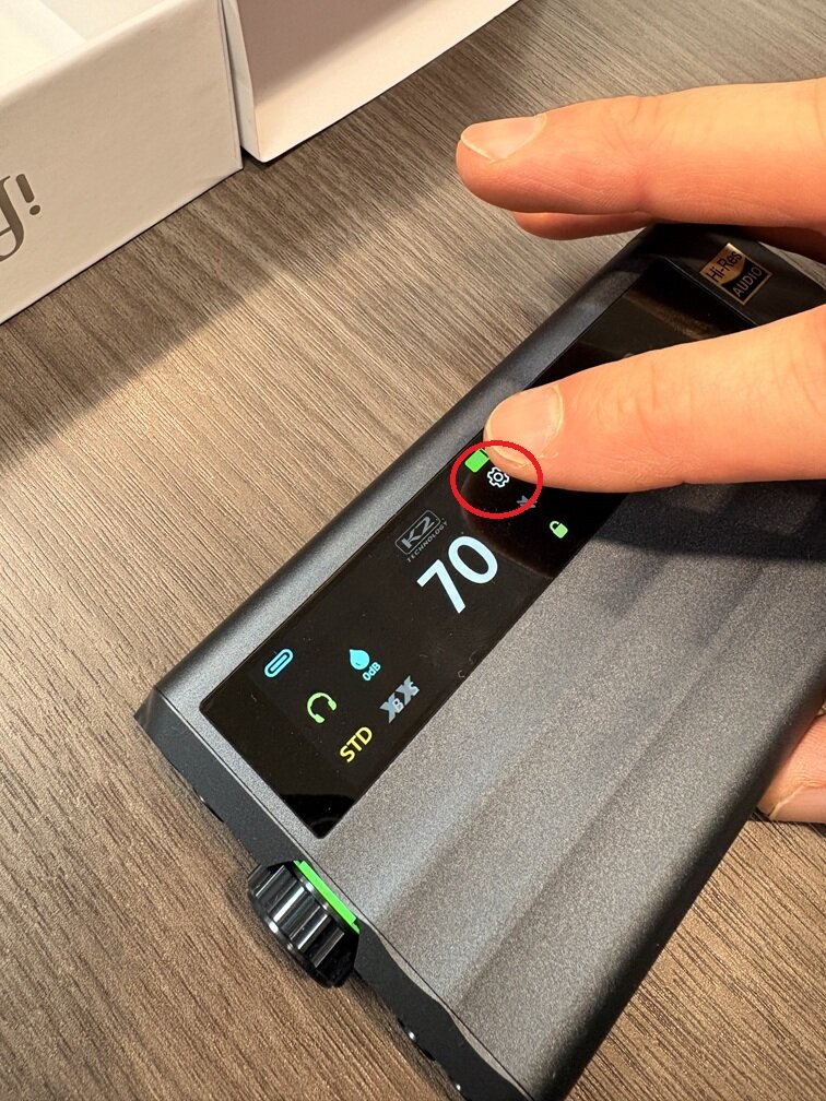 finger touching the settings button on the gr2 screen