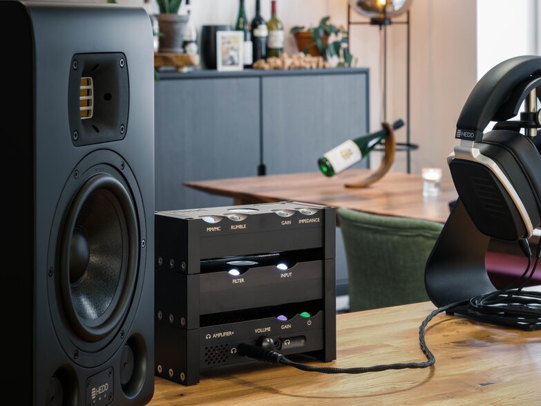 Huei is hooked up to headphones next to the speaker