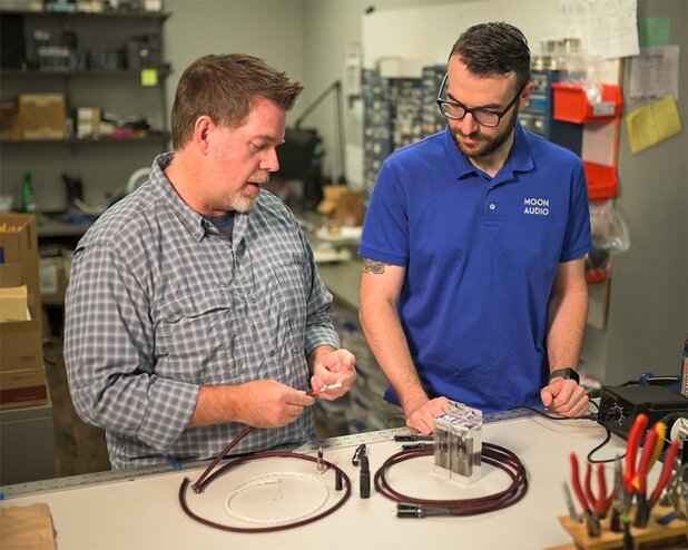 two moon audio employees working on dragon audio cables