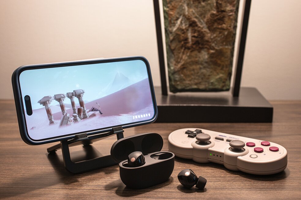 iPhone with controller and Sony XM5 Earbuds