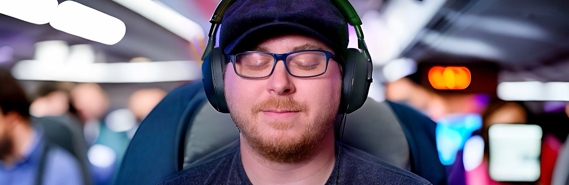 man listening to headphones on a plane