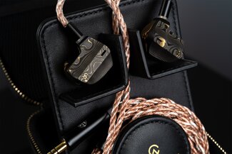 Campfire Audio Chimera IEMs with stock cable connected, displayed in hardshell case