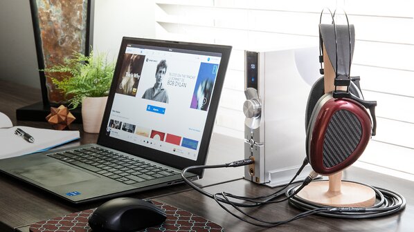 Headphones and iFi Neo iDSD 2 DAC Amp connected to a computer