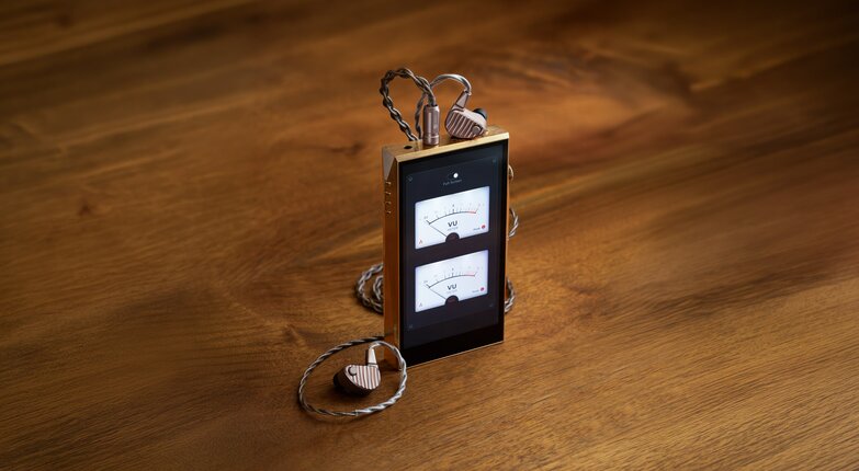 dap standing with ocean iems plugged in on wooden table