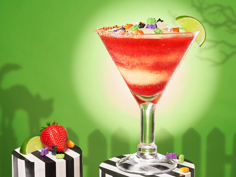 Chili's October Trick or Treat-A-Rita on a pedestal with a green background and spooky shadows