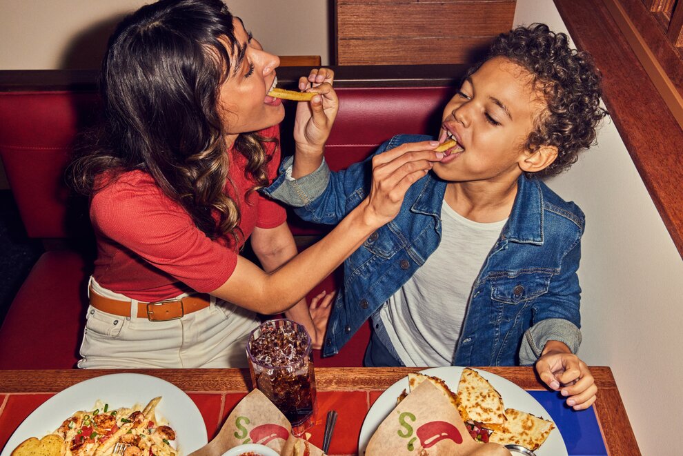 Mother & son enjoying a meal at Chili's together.