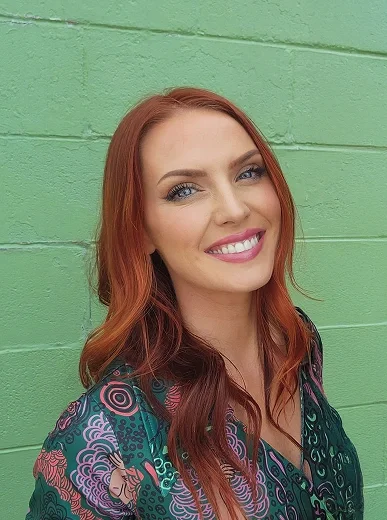 Casual selfie of a woman indoors with simple background
