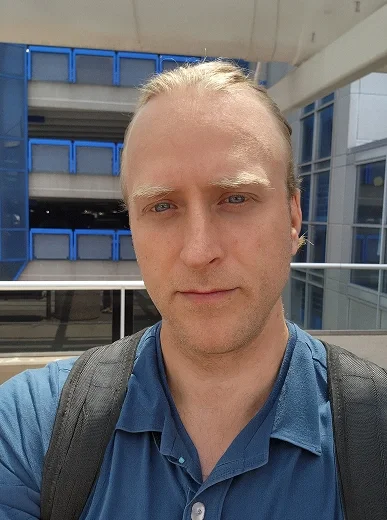 Candid snapshot of a man in casual clothes in a relaxed outdoor setting