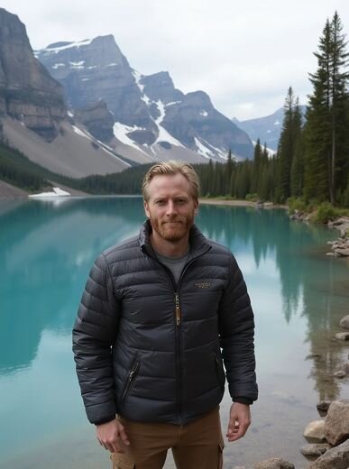 AI travel portrait of a man in a dark puffer jacket standing beside a turquoise alpine lake, surrounded by pine trees and snow-covered peaks—Somny’s realistic mountain destination styling.