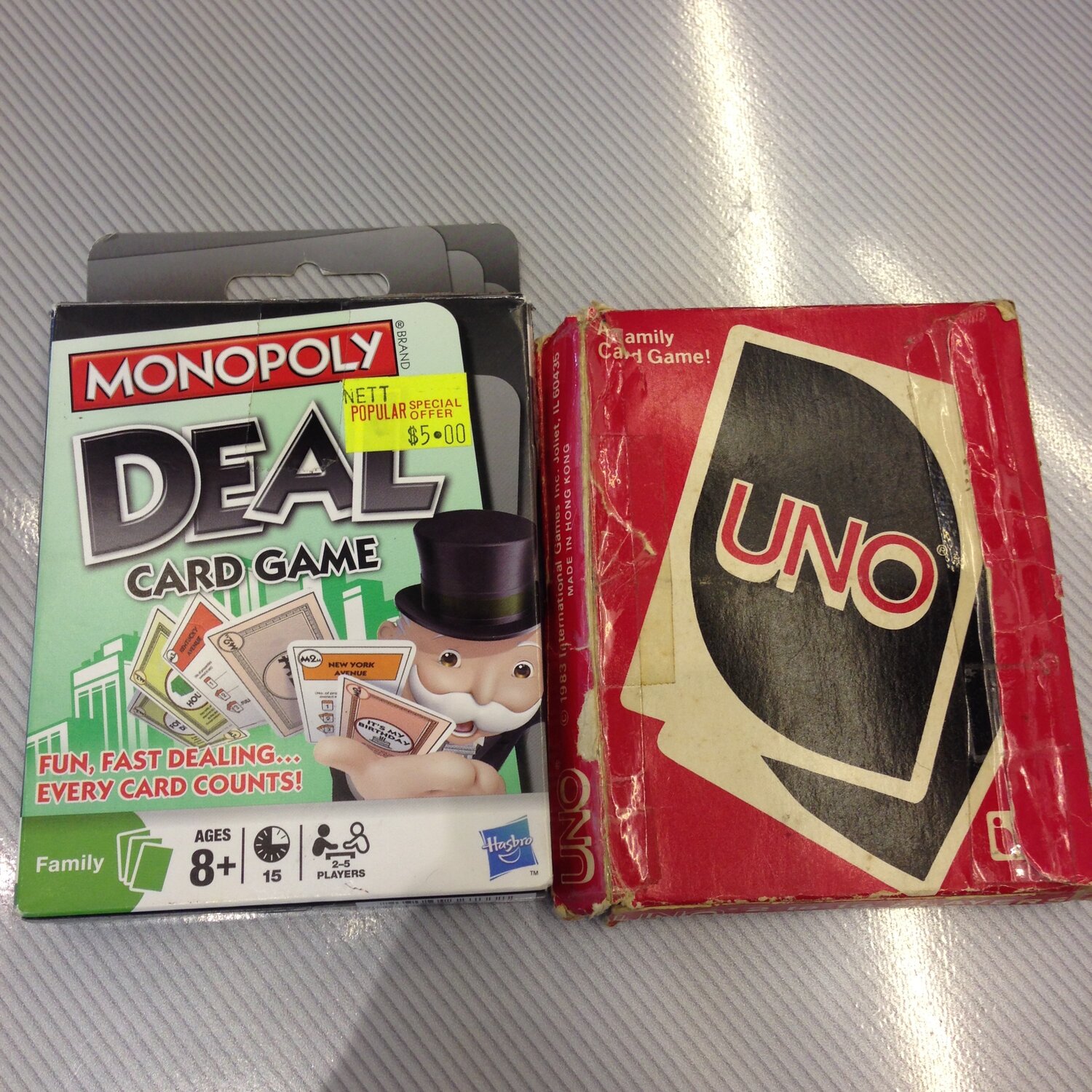 Deck Monopoly Deal card game and a deck of Uno Cards