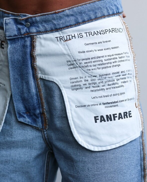 Circular Transition Indicators: progress over perfection. Denim jeans with 'Truth is transparency' printed on the pocket'. 