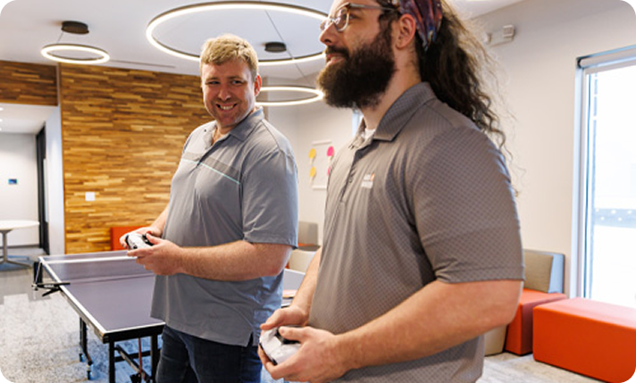 Gas South employees playing games in the recreational area of the office
