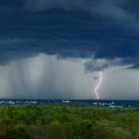 dark clouds and lightning storm over a field