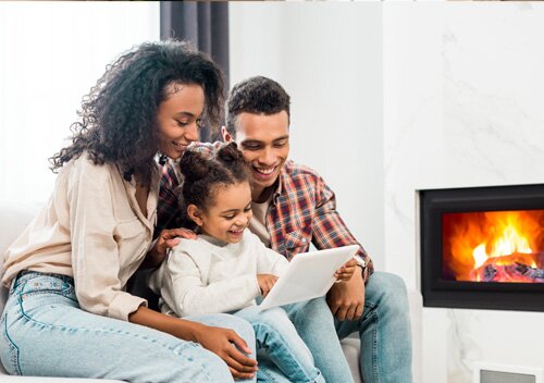 couple looking at their tablet near natural gas fireplace