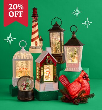 Three glitter lanterns lit up in front of a green background