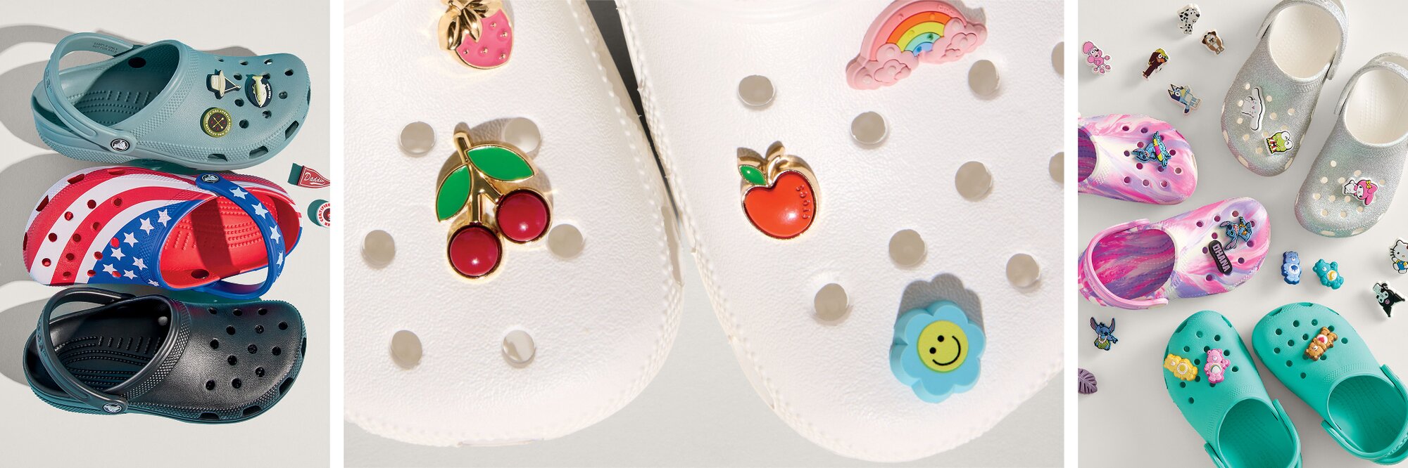 A three-panel image showcasing Crocs and decorative charms. On the left, three pairs of Crocs are stacked: a teal pair with small charms, a red-white-and-blue patriotic pair, and a black pair. In the center, a close-up of white Crocs highlights colorful charms including cherries, a peach, a rainbow, and a smiling flower. On the right, several Crocs in different styles—glittery silver flats, pink patterned clogs, and teal clogs—are arranged alongside an assortment of playful character charms scattered around them.