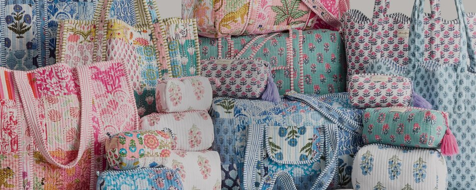 Image of patchwork strawflower tote, cosmetic bags, and duffel bags.
