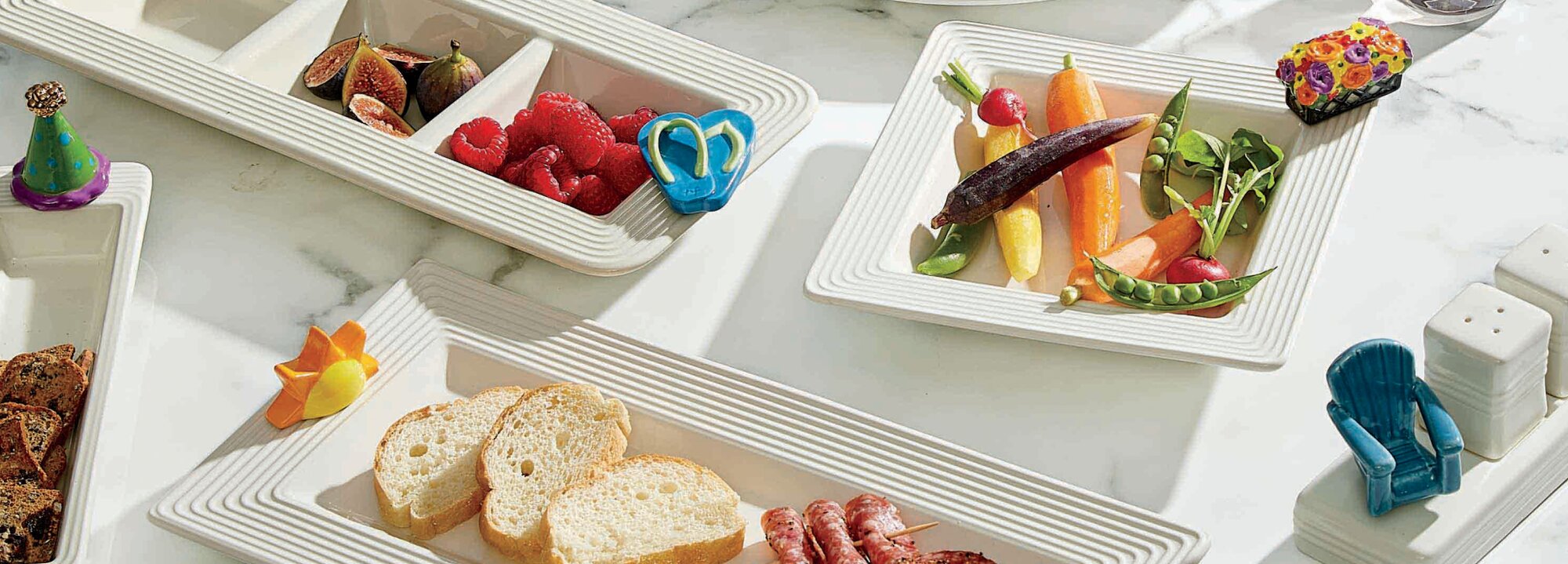 Image of various Nora fleming trays and platters with flip flop mini, sun mini, party hat mini, beach chair mini