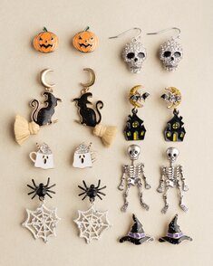 Two Halloween-themed ceramic bowls with black exteriors and festive interiors featuring bats, stars, spiderwebs, and spiders.