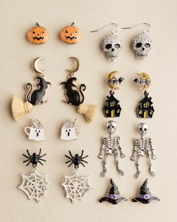 Two Halloween-themed ceramic bowls with black exteriors and festive interiors featuring bats, stars, spiderwebs, and spiders.