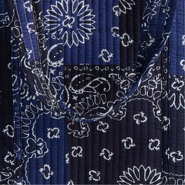 Close-up of navy quilted fabric with a white bandana-inspired print.