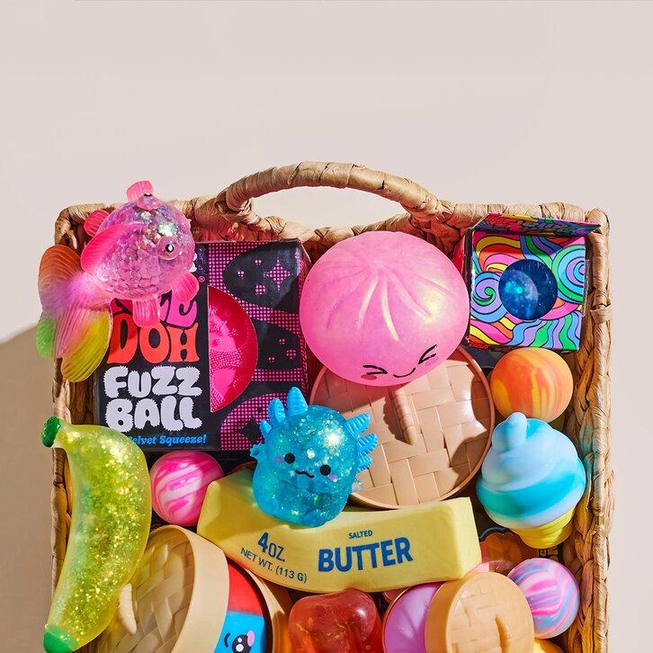 Image of a basket of various squishy toys, featuring NeeDoh, Dumplings, Butter and more