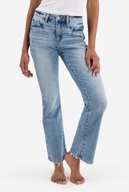 waist-down image of model wearing light wash relaxed fit jeans with distressed hem and rip at the knee