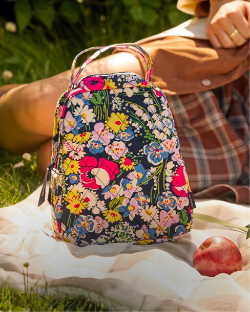 Floral lunchbox on a picnic blanket. Shop lunchboxes.
