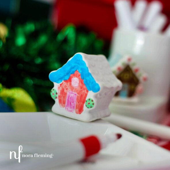 Person wearing layered silver Cape Cod–style bracelets outdoors.