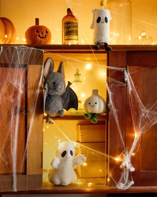 Halloween-themed Jellycat plush displayed in a miniature haunted house.