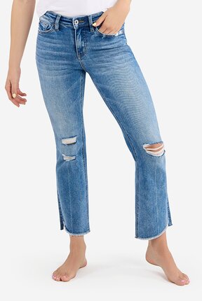 waist-down image of model wearing medium wash mid rise jeans with ripped knees