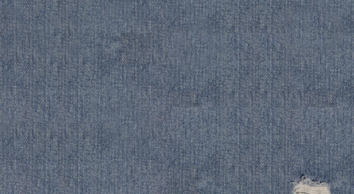 two models laying on a bed surrounded by valentine's day candy and valentine's jellycats. one model wearing a pink pajama set, the other wearing red striped boxer shorts and a white cardigan with a heart motif. 