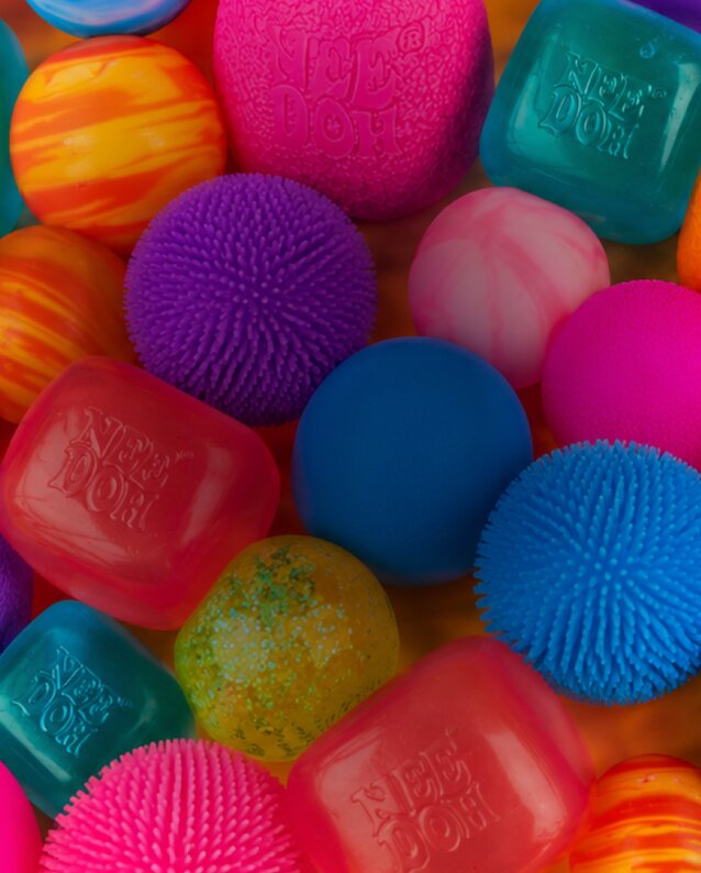 Colorful assortment of NeeDoh squishy sensory toys. Shop NeeDoh.