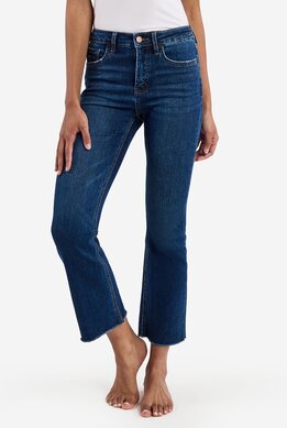 waist-down image of model wearing dark wash flare with distressed hem 