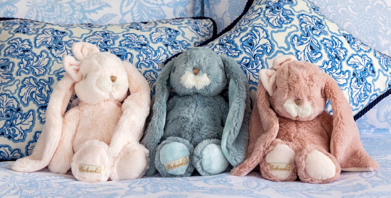 Image of a young girl holding two pink Bukowski bunnies at an easter brunch