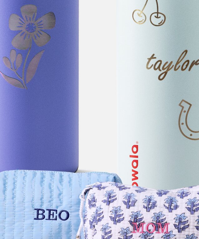 Close up of engraved water bottles and embroidered cosmetic pouches