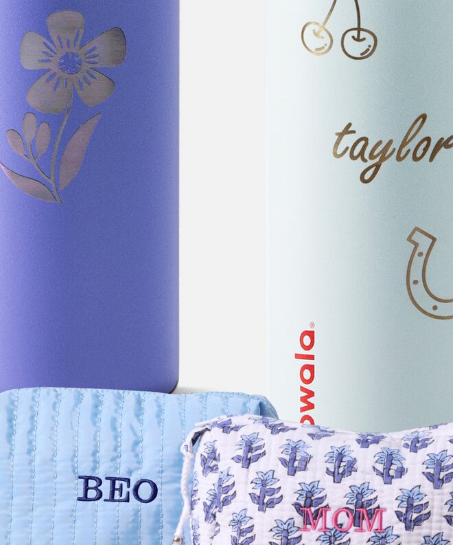 Close up of engraved water bottles and embroidered cosmetic pouches